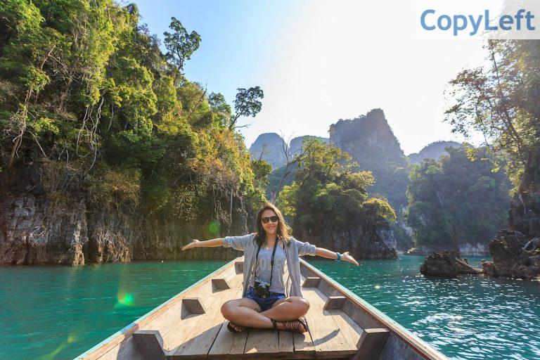 Photo of Woman Sitting on Boat Spreading Her Arms