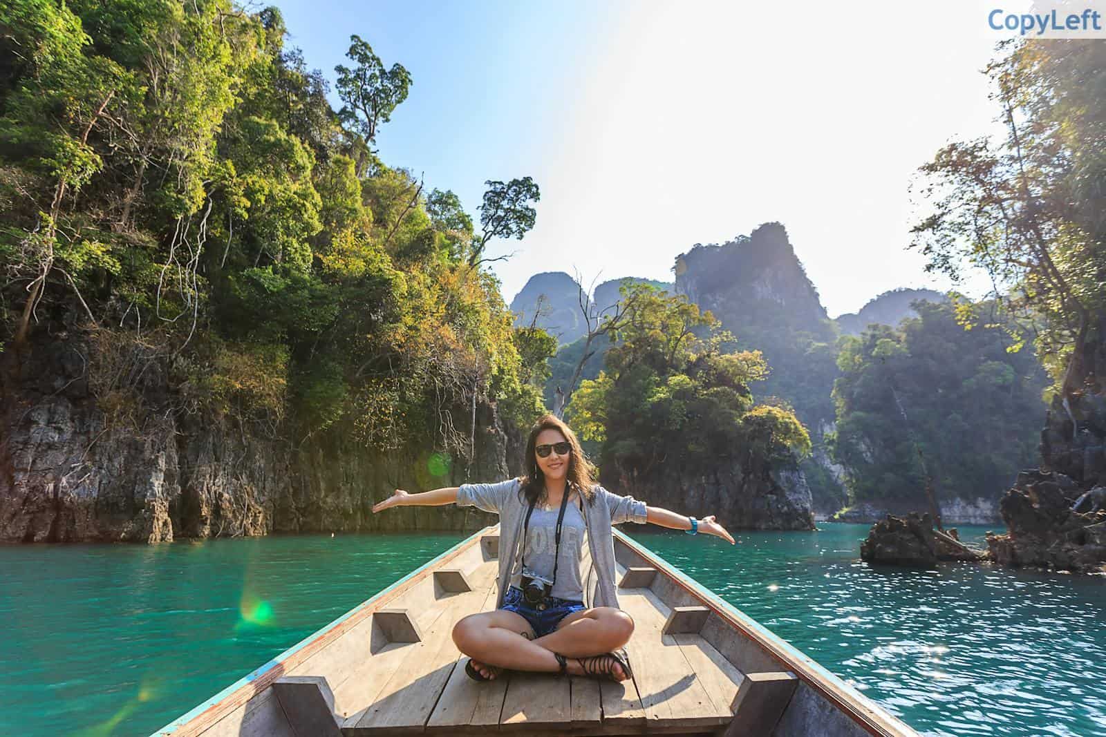 Photo of Woman Sitting on Boat Spreading Her Arms