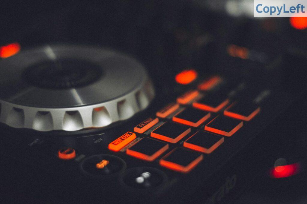 Close-up of a DJ controller with illuminated buttons and control knobs, ideal for music technology themes.